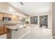 Open concept kitchen features island with sink, wood cabinets and view to breakfast nook at 3751 S Vista Pl, Chandler, AZ 85248