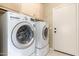 Laundry room with washer, dryer, tile floor, and storage cabinets above at 3751 S Vista Pl, Chandler, AZ 85248