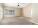 Spacious living room with neutral carpet, a ceiling fan, and bright windows at 3751 S Vista Pl, Chandler, AZ 85248