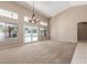 Bright, spacious living room featuring high ceilings, a modern chandelier, and seamless access to the backyard at 3751 S Vista Pl, Chandler, AZ 85248