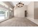 Bright, spacious living room featuring high ceilings, a modern chandelier, and seamless access to the backyard at 3751 S Vista Pl, Chandler, AZ 85248