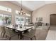 Bright living room with a dining table, high ceilings, and a large window showcasing the outdoor view at 3751 S Vista Pl, Chandler, AZ 85248