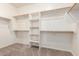 A walk-in closet with custom shelving and carpeted floors at 3751 S Vista Pl, Chandler, AZ 85248