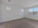 Sunlit room featuring neutral carpet, natural light from three windows, and an air vent at 4083 W Eli Dr, San Tan Valley, AZ 85144