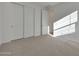 Bright bedroom featuring neutral carpet, ample natural light, and closet with sliding doors at 4083 W Eli Dr, San Tan Valley, AZ 85144