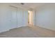 Spacious bedroom featuring neutral carpet, white walls, and a closet with sliding doors at 4083 W Eli Dr, San Tan Valley, AZ 85144