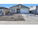 Charming single-story home featuring stone accents, a two-car garage, and desert landscaping at 4083 W Eli Dr, San Tan Valley, AZ 85144