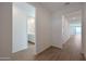 Bright hallway with wood-look tile flooring and views of the bathroom and the living room at 4083 W Eli Dr, San Tan Valley, AZ 85144