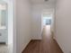 Bright hallway with wood-look tile flooring and views of the bathroom and the backyard at 4083 W Eli Dr, San Tan Valley, AZ 85144