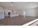 Bright and airy living room with a kitchen featuring stainless steel appliances and a large island at 4083 W Eli Dr, San Tan Valley, AZ 85144