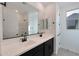 Modern bathroom with double sink vanity, black fixtures, and a large mirror at 4093 W Eli Dr, San Tan Valley, AZ 85144