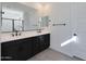 Stylish bathroom showcasing a double vanity with black fixtures, black cabinets, and a walk-in shower at 4093 W Eli Dr, San Tan Valley, AZ 85144