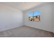 Bright bedroom with neutral carpet, white walls, and a window offering neighborhood views at 4093 W Eli Dr, San Tan Valley, AZ 85144