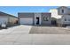 Modern home featuring a two-car garage, neutral color palette, and low-maintenance landscaping at 4093 W Eli Dr, San Tan Valley, AZ 85144