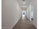 Long hallway with tile flooring, white walls, and recessed lighting leading to the backyard at 4093 W Eli Dr, San Tan Valley, AZ 85144