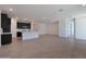 Spacious room with sleek flooring, recessed lighting, and a modern kitchen at 4093 W Eli Dr, San Tan Valley, AZ 85144