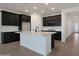 Open kitchen showcases modern dark cabinets, white countertops, and tiled backsplash at 4093 W Eli Dr, San Tan Valley, AZ 85144