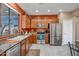 Well-lit kitchen featuring stainless steel appliances and ample wood cabinetry at 41012 N Noble Hawk Way, Anthem, AZ 85086