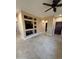 Open living space featuring built in shelving, a ceiling fan, and tile flooring at 41012 N Noble Hawk Way, Anthem, AZ 85086