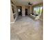 Bright living room featuring tile floors, a ceiling fan, and a sofa near a window at 41012 N Noble Hawk Way, Anthem, AZ 85086