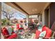 Comfortable outdoor patio with red furniture and a view of the landscaped backyard at 41012 N Noble Hawk Way, Anthem, AZ 85086