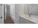 Bathroom featuring a white vanity with modern faucet, leading to a tub and shower combination at 4107 W Eli Dr, San Tan Valley, AZ 85144