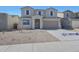 Two-story home featuring neutral colors, a two-car garage, and a low-maintenance gravel front yard at 4107 W Eli Dr, San Tan Valley, AZ 85144