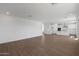 Spacious living room with light walls, recessed lighting, and wood-look tile flooring at 4107 W Eli Dr, San Tan Valley, AZ 85144