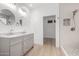 Bright bathroom featuring double vanity, grey cabinetry, and a modern walk-in shower at 41401 N Maidstone Ct, Anthem, AZ 85086