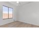 Bright bedroom featuring light wood floors and natural light from a large window at 41401 N Maidstone Ct, Anthem, AZ 85086