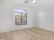 Bright, vacant bedroom with ceiling fan and a large window at 41401 N Maidstone Ct, Anthem, AZ 85086