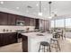 Modern kitchen features stainless steel appliances, a large island, and sleek cabinetry at 41401 N Maidstone Ct, Anthem, AZ 85086