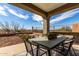 Inviting covered patio featuring outdoor dining furniture and expansive views at 41401 N Maidstone Ct, Anthem, AZ 85086