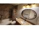 Well-lit bathroom features decorative tiles, granite counters, and stylish oval mirror at 4226 E Jojoba Rd, Phoenix, AZ 85044