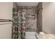 Bathroom featuring a shower and tub with tiled walls and a decorative accent stripe at 4226 E Jojoba Rd, Phoenix, AZ 85044