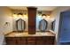 Bathroom boasts double sinks, granite countertops, and elegant vanity lighting at 4226 E Jojoba Rd, Phoenix, AZ 85044