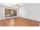 Bedroom with a ceiling fan, wood floor, and a large window at 4226 E Jojoba Rd, Phoenix, AZ 85044