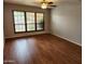Spacious bedroom with wood-look floors and natural light from the large window at 4226 E Jojoba Rd, Phoenix, AZ 85044