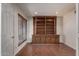 Private den with built-in shelving, hardwood floors, and natural light from the window at 4226 E Jojoba Rd, Phoenix, AZ 85044