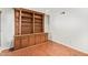 Cozy den area featuring a custom built-in bookcase and stylish hardwood flooring at 4226 E Jojoba Rd, Phoenix, AZ 85044