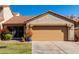 Charming single-Gathering home featuring a two-car garage, beautiful landscaping, and a classic desert tile roof at 4226 E Jojoba Rd, Phoenix, AZ 85044