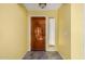 Bright and airy foyer with ceramic tile flooring, and a solid wood front door, perfect for welcoming guests at 4226 E Jojoba Rd, Phoenix, AZ 85044