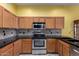 Well-appointed kitchen with stainless steel appliances and wooden cabinetry at 4226 E Jojoba Rd, Phoenix, AZ 85044