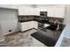 Kitchen with island, black countertops, and stainless steel oven at 4226 E Jojoba Rd, Phoenix, AZ 85044