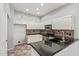 Well-lit kitchen featuring a breakfast bar and modern appliances at 4226 E Jojoba Rd, Phoenix, AZ 85044