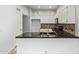 Bright kitchen with white cabinetry, black countertops, and stainless steel appliances at 4226 E Jojoba Rd, Phoenix, AZ 85044