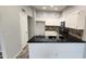 Updated kitchen with white cabinets and black countertops at 4226 E Jojoba Rd, Phoenix, AZ 85044