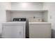 Laundry room with a standard size washer and dryer and a shelf above at 4226 E Jojoba Rd, Phoenix, AZ 85044