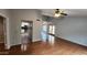 Open living room with a ceiling fan, hard wood floors, and view into the kitchen at 4226 E Jojoba Rd, Phoenix, AZ 85044