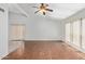 Open living area with a ceiling fan, wood floors, and natural light streaming through large windows at 4226 E Jojoba Rd, Phoenix, AZ 85044